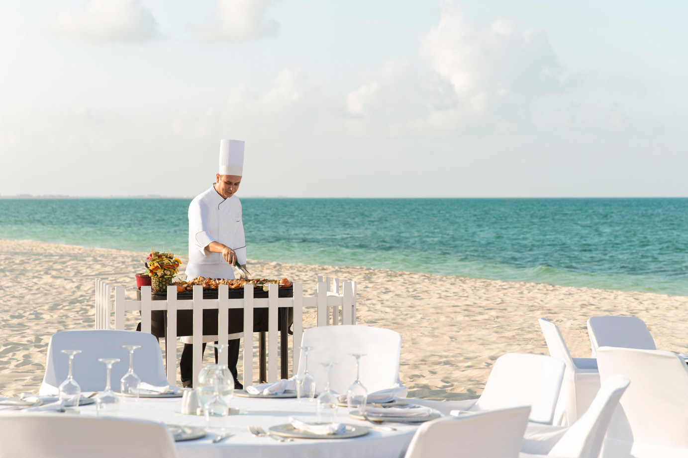 Chef cooking on the white sands of Cancuns beaches Chef cooking on the white sands of Cancuns beaches