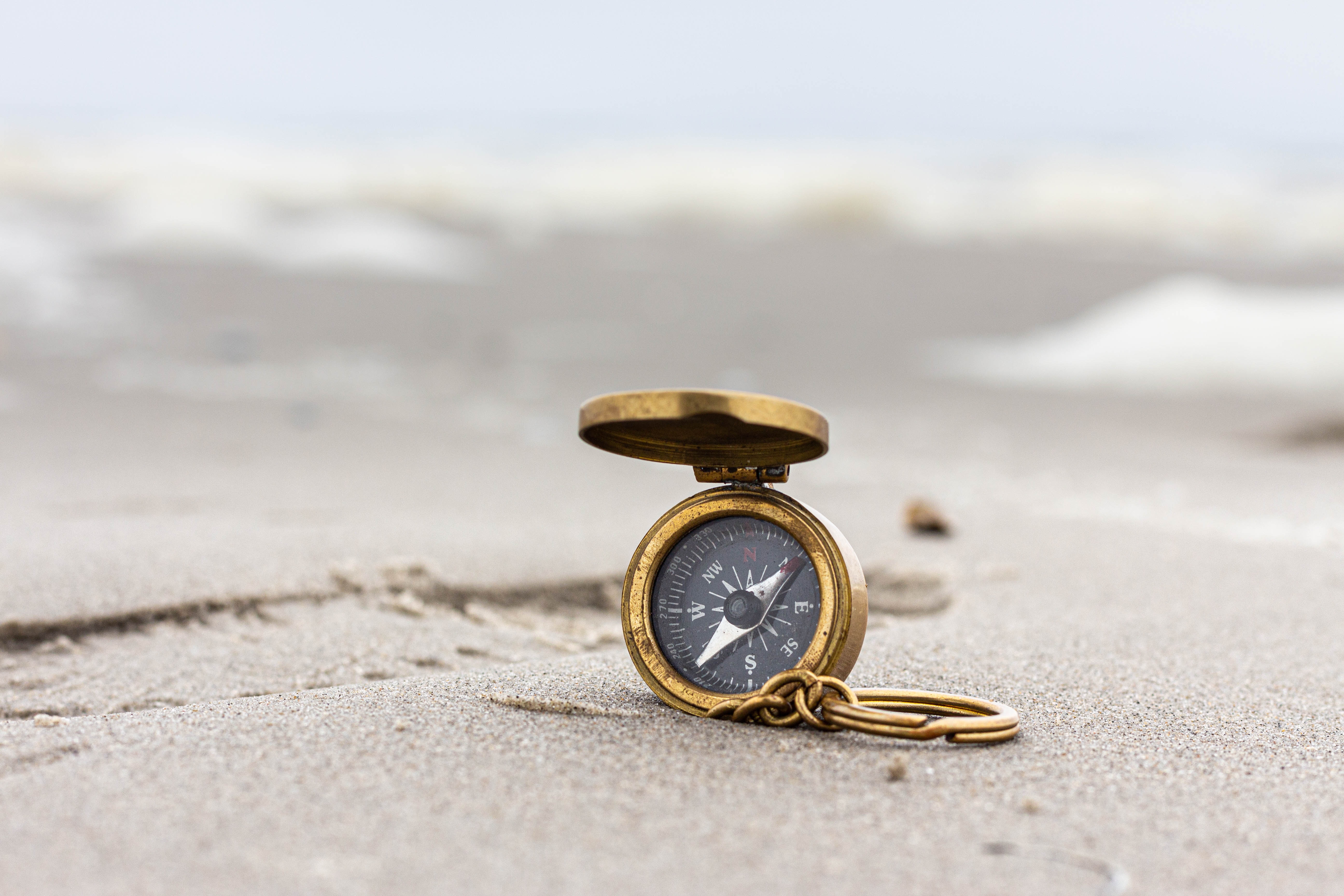 Compass on a Cancun beach showing which way to go